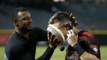 PHOENIX, ARIZONA - SEPTEMBER 16: Jake Lamb #22 of the Arizona Diamondbacks (R) gets a pie in his face from teammate Adam Jones following a 7-5 victory against the Miami Marlins during the MLB game at Chase Field on September 16, 2019 in Phoenix, Arizona. Lamb had a 3-RBI double in the seventh in the Diamondbacks win. (Photo by Ralph Freso/Getty Images)