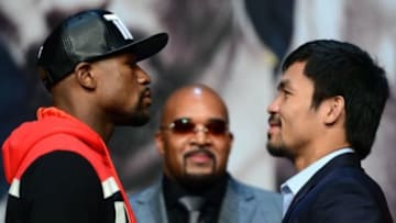 Apr 29, 2015; Las Vegas, NV, USA; Floyd Mayweather and Manny Pacquiao face off as Floyd Mayweather advisor Leonard Ellerbe looks on during a press conference at KA Theatre. Mandatory Credit: Joe Camporeale-USA TODAY Sports