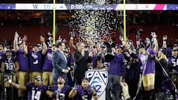 SANTA CLARA, CA - NOVEMBER 30: Head coach Chris Petersen of the Washington Huskies is given the championship trophy after the Huskies beat the Utah Utes to win the Pac 12 Championship game at Levi's Stadium on November 30, 2018 in Santa Clara, California. (Photo by Ezra Shaw/Getty Images)