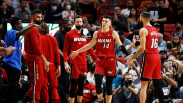 Tyler Herro #14 of the Miami Heat celebrates with teammates (Photo by Cliff Hawkins/Getty Images)