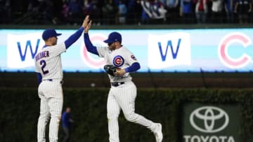 Jun 15, 2023; Chicago, Illinois, USA; Chicago Cubs left fielder Ian Happ (8) and second baseman Nico Hoerner (2) celebrate their win against the Pittsburgh Pirates at Wrigley Field. Mandatory Credit: David Banks-USA TODAY Sports
