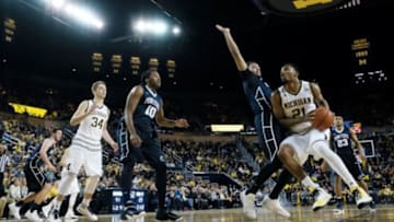 Jan 2, 2016; Ann Arbor, MI, USA; Michigan Wolverines guard Zak Irvin (21) moves the ball on Penn State Nittany Lions forward Payton Banks (0) in the first half at Crisler Center. Mandatory Credit: Rick Osentoski-USA TODAY Sports