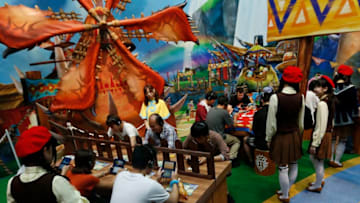 CHIBA, JAPAN - SEPTEMBER 17: Visitors play Monster Hunter Stories video games on Nintendo Co. 3DS portable video game players in the Capcom Co. booth at Tokyo Game Show on September 17, 2016 in Chiba, Japan. Tokyo Game Show 2016 is held from September 15 to September 18, 2016. (Photo by Yuya Shino/Getty Images for TOKYO GAME SHOW)