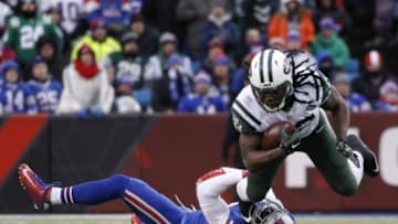 Jan 3, 2016; Orchard Park, NY, USA; New York Jets running back Chris Ivory (33) breaks a tackle by Buffalo Bills strong safety Bacarri Rambo (30) during the second half at Ralph Wilson Stadium. Bills beat the Jets 22-17. Mandatory Credit: Kevin Hoffman-USA TODAY Sports