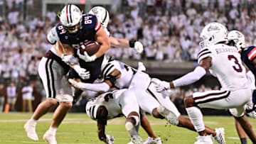 Sep 9, 2023; Starkville, Mississippi, USA; Arizona Wildcats tight end Tanner McLachlan (84) is tackled by Mississippi State Bulldogs safety Chris Keys (27) and linebacker Jett Johnson (44) during the second half at Davis Wade Stadium at Scott Field. Mandatory Credit: Matt Bush-USA TODAY Sports