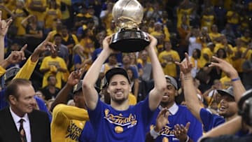 May 30, 2016; Oakland, CA, USA; Golden State Warriors guard Klay Thompson (11) hoists the trophy after game seven of the Western conference finals of the NBA Playoffs against the Oklahoma City Thunder at Oracle Arena. The Warriors defeated the Thunder 96-88. Mandatory Credit: Kyle Terada-USA TODAY Sports
