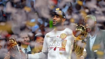 Jun 20, 2013; Miami, FL, USA; Miami Heat small forward LeBron James holds the MVP trophy and the Larry O