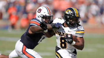 Auburn footballSep 24, 2022; Auburn, Alabama, USA; Missouri Tigers running back Nathaniel Peat (8) it tackled by Auburn Tigers linebacker Owen Pappoe (0) during the first overtime at Jordan-Hare Stadium. Mandatory Credit: John Reed-USA TODAY Sports