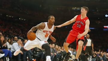 Apr 16, 2014; New York, NY, USA; New York Knicks guard J.R. Smith (8) handles the ball against Toronto Raptors forward Tyler Hansbrough (50) during the second half at Madison Square Garden. New York Knicks defeat the Toronto Raptors 95-92. Mandatory Credit: Jim O