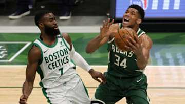 MILWAUKEE, WISCONSIN - MARCH 24: Giannis Antetokounmpo #34 of the Milwaukee Bucks is defended by Jaylen Brown #7 of the Boston Celtics during the second half of a game at Fiserv Forum on March 24, 2021 in Milwaukee, Wisconsin. NOTE TO USER: User expressly acknowledges and agrees that, by downloading and or using this photograph, User is consenting to the terms and conditions of the Getty Images License Agreement. (Photo by Stacy Revere/Getty Images)