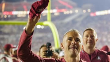Florida State Seminoles head coach Mike Norvell tosses his hat to a fan after the Seminoles' victory. The Florida State Seminoles defeated the Miami Hurricanes 31-28 Saturday, Nov. 13, 2021.Fsu V Miami Second Half947