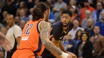 Dec 4, 2016; Oklahoma City, OK, USA; New Orleans Pelicans forward Anthony Davis (23) handles the ball in front of Oklahoma City Thunder center Steven Adams (12) during the first quarter at Chesapeake Energy Arena. Mandatory Credit: Mark D. Smith-USA TODAY Sports