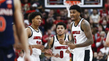 LOUISVILLE, KENTUCKY - FEBRUARY 08: Lamarr Kimble #0, Malik Williams #5 and Dwayne Sutton #24 of the Louisville Cardinals huddle during the final seconds of the game against the Virginia Cavaliers at KFC YUM! Center on February 08, 2020 in Louisville, Kentucky. (Photo by Silas Walker/Getty Images)