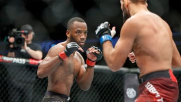 British fighter Leon Edwards (L) and German born fighter Peter Sobotta in their Welterweight fight during the UFC Fight Night at the O2 Arena in London on March 17, 2018.Accused of promoting an ultra-violent spectacle by allowing strikes on an opponent on the ground, the organization has put in place protocols to secure the health of athletes, including monitoring the impact on the brain of blows to the head. / AFP PHOTO / Tolga Akmen (Photo credit should read TOLGA AKMEN/AFP/Getty Images)