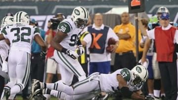Aug 26, 2012; East Rutherford, NJ, USA; New York Jets linebacker Calvin Pace (97) and defensive end Quinton Coples (98) try to recover a fumble by Carolina Panthers running back DeAngelo Williams (not pictured) during the first half at MetLife Stadium. Mandatory Credit: Ed Mulholland-USA TODAY Sports