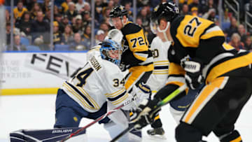 Mar 5, 2020; Buffalo, New York, USA; Buffalo Sabres goaltender Jonas Johansson (34) makes a save as Pittsburgh Penguins center Nick Bjugstad (27) gets the rebound during the third period at KeyBank Center. Mandatory Credit: Timothy T. Ludwig-USA TODAY Sports