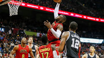 Jan 1, 2017; Atlanta, GA, USA; Atlanta Hawks forward Paul Millsap (4) grabs a rebound against the San Antonio Spurs in the fourth quarter at Philips Arena. The Hawks won 114-112 in overtime. Mandatory Credit: Brett Davis-USA TODAY Sports
