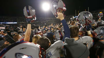 EAST HARTFORD, CT - NOVEMBER 21: Players and fans of the Connecticut Huskies celebrate their 20-17 win over the 13th ranked Houston Cougars at Rentschler Field on November 21, 2015 in East Hartford, Connecticut. (Photo by Rich Schultz /Getty Images)