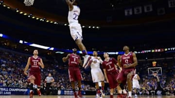 Mar 21, 2014; St. Louis, MO, USA; Kansas Jayhawks guard Andrew Wiggins (22) dunks the ball ahead of Eastern Kentucky Colonels guard Isaac McGlone (5), Glenn Cosey (0) and Marcus Lewis (12) in the first half during the 2nd round of the 2014 NCAA Men