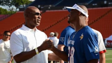 January 26, 2013; Honolulu, HI, USA; Hall of Fame running back Eric Dickerson (left) shakes hands with NFC running back Adrian Peterson of the Minnesota Vikings (28, right) during the NFC practice on Ohana Day at the 2013 Pro Bowl. Mandatory Credit: Kyle Terada-USA TODAY Sports
