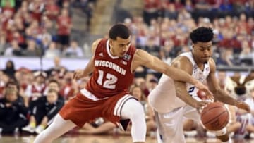 Apr 6, 2015; Indianapolis, IN, USA; Wisconsin Badgers guard Traevon Jackson (12) and Duke Blue Devils guard Quinn Cook (2) battle for a loose ball during the second half in the 2015 NCAA Men's Division I Championship game at Lucas Oil Stadium. Mandatory Credit: Robert Deutsch-USA TODAY Sports