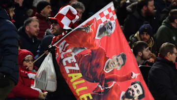 A Liverpool fan carries a flag as he leaves following the English Premier League football match between Liverpool and West Ham United at Anfield in Liverpool, north west England on February 24, 2020. (Photo by Paul ELLIS / AFP) / RESTRICTED TO EDITORIAL USE. No use with unauthorized audio, video, data, fixture lists, club/league logos or 'live' services. Online in-match use limited to 120 images. An additional 40 images may be used in extra time. No video emulation. Social media in-match use limited to 120 images. An additional 40 images may be used in extra time. No use in betting publications, games or single club/league/player publications. / (Photo by PAUL ELLIS/AFP via Getty Images)