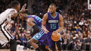 Jan 7, 2017; San Antonio, TX, USA; Charlotte Hornets point guard Kemba Walker (15) dribbles the ball as San Antonio Spurs center Dewayne Dedmon (3, left) defends during the second half at AT&T Center. Mandatory Credit: Soobum Im-USA TODAY Sports