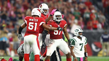 Oct 17, 2016; Glendale, AZ, USA; Arizona Cardinals linebacker Alex Okafor (57) celebrates with teammate Kevin Minter (51) after sacking New York Jets quarterback Geno Smith (7) in the fourth quarter at University of Phoenix Stadium. The Cardinals defeated the Jets 28-3. Mandatory Credit: Mark J. Rebilas-USA TODAY Sports
