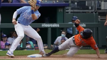 KANSAS CITY, MISSOURI - AUGUST 19: Jose Altuve #27 of the Houston Astros slides into third for a steal against Hunter Dozier #17 of the Kansas City Royals in the seventh inning at Kauffman Stadium on August 19, 2021 in Kansas City, Missouri. (Photo by Ed Zurga/Getty Images)
