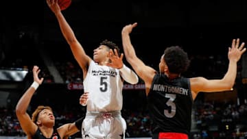 ATLANTA, GA - MARCH 28: Quentin Grimes #5 of The Woodlands College Park H.S. attacks the basket against Romeo Langford #22 of New Albany High School and EJ Montgomery #3 of Wheeler High School during the 2018 McDonald's All American Game at Philips Arena on March 28, 2018 in Atlanta, Georgia. (Photo by Kevin C. Cox/Getty Images)