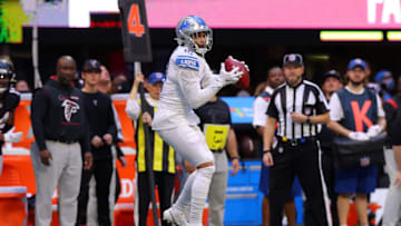ATLANTA, GEORGIA - DECEMBER 26: Amon-Ra St. Brown #14 of the Detroit Lions catches the ball before running into the end zone for a touchdown reception against the Atlanta Falcons in the second quarter at Mercedes-Benz Stadium on December 26, 2021 in Atlanta, Georgia. (Photo by Todd Kirkland/Getty Images)