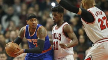 Jan 1, 2016; Chicago, IL, USA; New York Knicks forward Carmelo Anthony (7)is defended by Chicago Bulls guard Jimmy Butler (21) and forward Taj Gibson (22) during the first half at United Center. Mandatory Credit: Kamil Krzaczynski-USA TODAY Sports