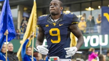 Nov 28, 2015; Morgantown, WV, USA; West Virginia Mountaineers safety KJ Dillon (9) is honored on senior day before their game against the Iowa State Cyclones at Milan Puskar Stadium. Mandatory Credit: Ben Queen-USA TODAY Sports