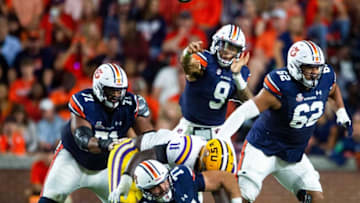 Auburn football quarterback Robby Ashford (9) passes behind offensive lineman Brandon Council (71), offensive lineman Kilian Zierer (77) and offensive lineman Kameron Stutts (62) against LSU as the Auburn Tigers take on the LSU Tigers at Jordan-Hare Stadium in Auburn, Ala., on Saturday, Oct. 1, 2022.Aulsu14