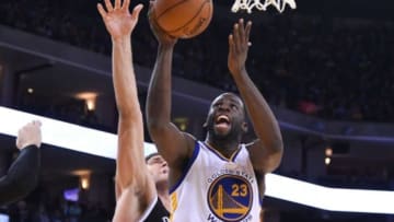 November 13, 2014; Oakland, CA, USA; Golden State Warriors forward Draymond Green (23) shoots the basketball against Brooklyn Nets center Brook Lopez (11) during the third quarter at Oracle Arena. The Warriors defeated the Nets 107-99. Mandatory Credit: Kyle Terada-USA TODAY Sports