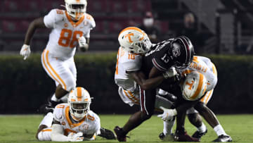 COLUMBIA, SOUTH CAROLINA - SEPTEMBER 26: Defensive back Doneiko Slaughter #18 and defensive back Trevon Flowers #1 of the Tennessee Volunteers tackle wide receiver Shi Smith #13 of the South Carolina Gamecocks as defensive back Bryce Thompson #0 and defensive lineman LaTrell Bumphus #88 of the Tennessee Volunteers look on during the football game at Williams-Brice Stadium on September 26, 2020 in Columbia, South Carolina. (Photo by Mike Comer/Getty Images)
