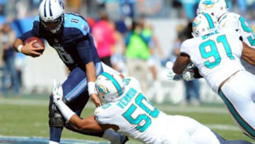 Oct 18, 2015; Nashville, TN, USA; Tennessee Titans quarterback Marcus Mariota (8) is sacked by Miami Dolphins defensive end Olivier Vernon (50) and defensive end Cameron Wake (91) during the first half at Nissan Stadium. Mandatory Credit: Christopher Hanewinckel-USA TODAY Sports