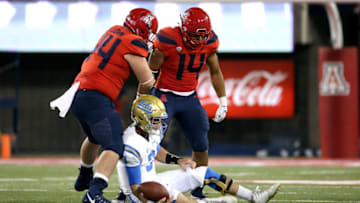 TUCSON, AZ - OCTOBER 14: Defensive end Kylan Wilborn #14 of the Arizona Wildcats and defensive lineman Kurtis Brown #44 react after recording a sack on quarterback Josh Rosen #3 of the UCLA Bruins during the second half of the college football game at Arizona Stadium on October 14, 2017 in Tucson, Arizona. (Photo by Chris Coduto/Getty Images)