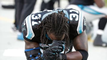 Jan 3, 2016; Charlotte, NC, USA; Carolina Panthers cornerback Charles Tillman (31) prays on the sidelines during an injured player timeout in the first quarter against the Tampa Bay Buccaneers at Bank of America Stadium. Mandatory Credit: Jeremy Brevard-USA TODAY Sports