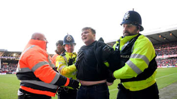 A Leicester City 'fan' is arrested after attacking Nottingham Forest players on the pitch (Photo by Laurence Griffiths/Getty Images)