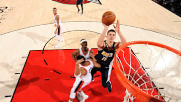 PORTLAND, OR - NOVEMBER 13: Nikola Jokic #15 of the Denver Nuggets goes to the basket against the Portland Trail Blazers on November 13, 2017 at the Moda Center in Portland, Oregon. NOTE TO USER: User expressly acknowledges and agrees that, by downloading and or using this Photograph, user is consenting to the terms and conditions of the Getty Images License Agreement. Mandatory Copyright Notice: Copyright 2017 NBAE (Photo by Cameron Browne/NBAE via Getty Images)