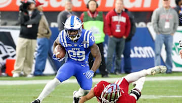 Dec 26, 2015; Bronx, NY, USA; Duke Blue Devils running back Shaun Wilson (29) rushes in front of Indiana Hoosiers linebacker Marcus Oliver (44) during the 2015 New Era Pinstripe Bowl at Yankee Stadium. The Blue Devils won 44-41 in overtime. Mandatory Credit: Vincent Carchietta-USA TODAY Sports
