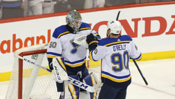 WINNIPEG, MANITOBA - APRIL 10: Ryan O'Reilly #90 of the St. Louis Blues congratulates goaltender Jordan Binnington #50 after defeating the Winnipeg Jets in Game One of the Western Conference First Round during the 2019 NHL Stanley Cup Playoffs at Bell MTS Place on April 10, 2019 in Winnipeg, Manitoba, Canada. (Photo by Jason Halstead/Getty Images)