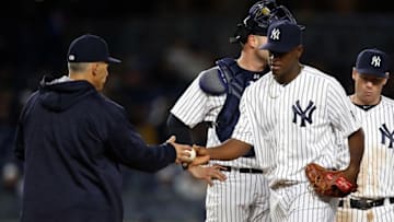Apr 15, 2016; Bronx, NY, USA; New York Yankees manager Joe Girardi (left) takes the ball away from New York Yankees starting pitcher Luis Severino (right) in the sixth inning against the Seattle Mariners at Yankee Stadium. Mandatory Credit: Noah K. Murray-USA TODAY Sports