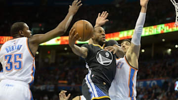 Feb 27, 2016; Oklahoma City, OK, USA; Golden State Warriors forward Andre Iguodala (9) drives to the basket in front of Oklahoma City Thunder center Enes Kanter (11) and forward Kevin Durant (35) during the second quarter at Chesapeake Energy Arena. Mandatory Credit: Mark D. Smith-USA TODAY Sports