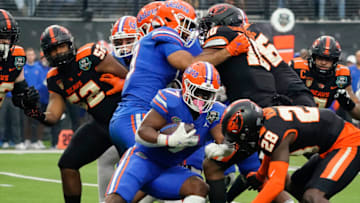 Dec 17, 2022; Las Vegas, NV, USA; Florida Gators running back Trevor Etienne (7) runs with the ball through the Oregon State Beavers defense during the first half at the Las Vegas Bowl at Allegiant Stadium. Mandatory Credit: Lucas Peltier-USA TODAY Sports