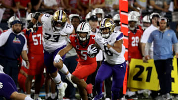 Sep 30, 2023; Tucson, Arizona, USA; Washington Huskies running back Will Nixon (8) runs for a first down agaisnt Arizona Wildcats linebacker Jacob Manu (5) in the first half at Arizona Stadium. Mandatory Credit: Zachary BonDurant-USA TODAY Sports