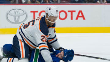Edmonton Oilers defenseman Darnell Nurse, #25, battles with Vancouver Canucks forward Conor Garland, #8 Mandatory Credit: Bob Frid-USA TODAY Sports