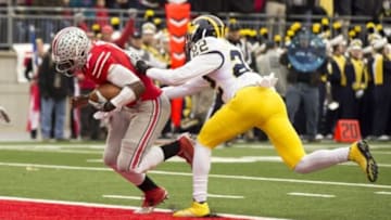 Nov 29, 2014; Columbus, OH, USA; Ohio State Buckeyes quarterback J.T. Barrett (16) scores as Michigan Wolverines safety Jarrod Wilson (22) misses a tackle at Ohio Stadium. Mandatory Credit: Greg Bartram-USA TODAY Sports