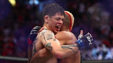 Jun 12, 2021; Glendale, Arizona, USA; Brandon Moreno meets with Deiveson Figueiredo following his championship victory during UFC 263 at Gila River Arena. Mandatory Credit: Mark J. Rebilas-USA TODAY Sports